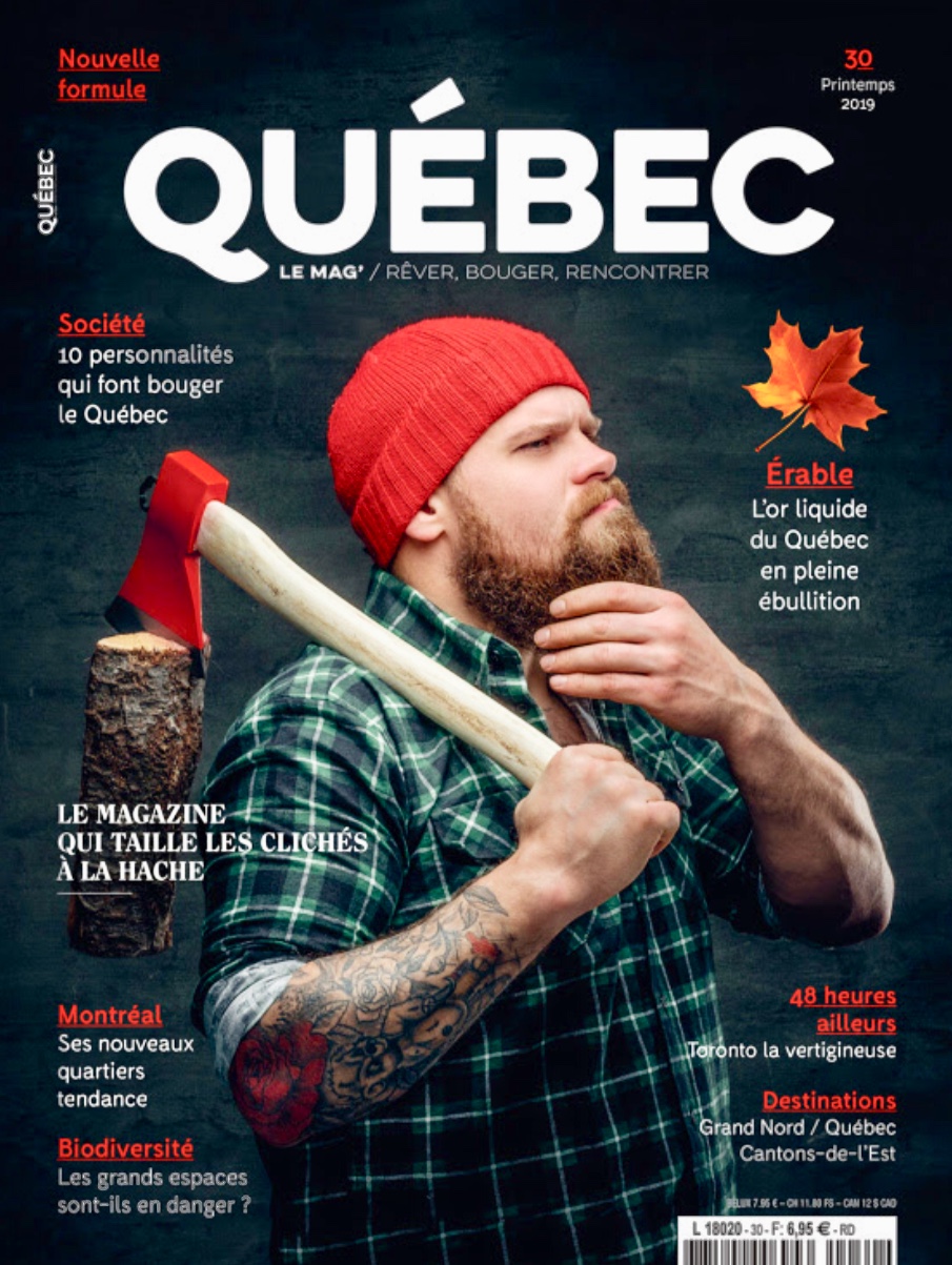 La couverture du magazine Québec mettant en vedette un homme barbu avec une hache.