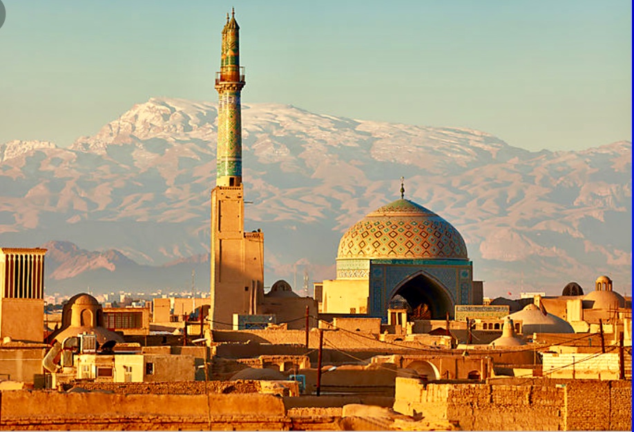 Description : Une ville d'Iran avec des montagnes enneigées en arrière-plan, affichant une belle combinaison de vie urbaine et de paysages naturels impressionnants.