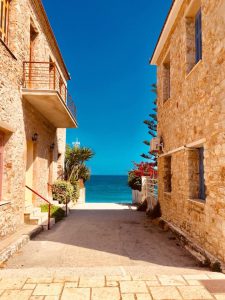 Une allée de pierre menant à la plage en Crète, en Grèce, mettant en valeur la beauté du régime méditerranéen.