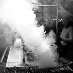 Photo en noir et blanc de la fumée sortant d’un grill au Cambodge.