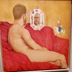 Une exposition à Paris présentant un tableau représentant un homme nu assis sur un canapé rouge.