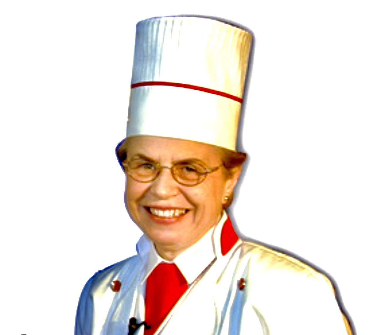 Une femme coiffée d'une toque blanche souriant tout en préparant des recettes.