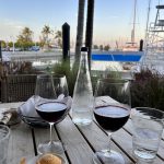 Deux verres de vin sur une table à côté d'un bateau pendant Les Keys en 5 jours jour 3.